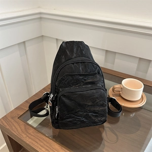 Fashionable black crinkled chest bag with multi-layer zippers and adjustable strap