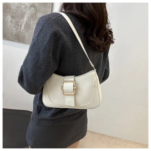 Detail of off-white PU leather shoulder bag with gold square buckle and wide strap
