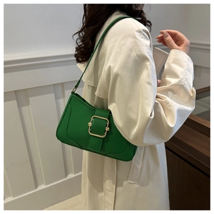 Close-up of a green leather crescent bag with a bold gold square buckle for women