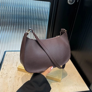 Minimalist coffee brown crescent shoulder bag with lychee texture and gold hardware