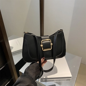 Chic black leather underarm bag with sleek crescent shape and bold gold square buckle