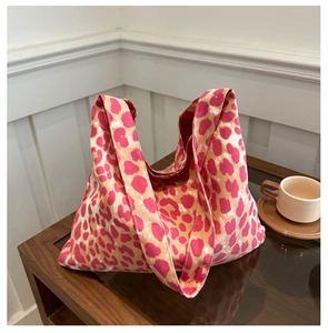 Close-up of durable canvas tote bag featuring a pink and beige leopard print pattern