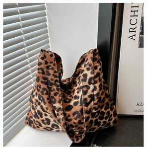 Detail of durable leopard print canvas tote bag with dual handles in lifestyle setting