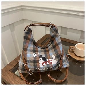Detail of retro plaid tote bag featuring cartoon embroidery and adjustable leather strap