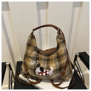 Detail of plaid wool tote bag with cartoon dog print and leather shoulder strap
