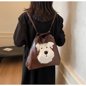 Detail view of large capacity faux leather bag with 3D plush dog face on front