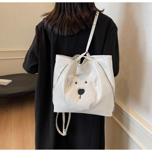 Detail of white glossy PU leather tote bag with a 3D plush Schnauzer dog design