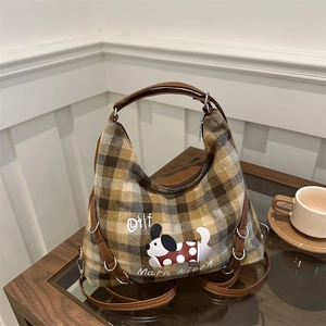 Plaid canvas tote bag with brown leather handles and a cartoon dachshund print on top