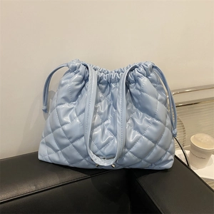 Light blue quilted puffer tote bag with drawstring closure and glossy finish for women