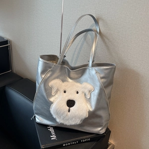Silver metallic tote bag featuring a plush dog patch design with long shoulder straps