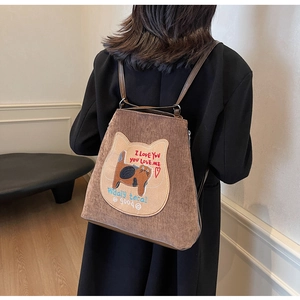 Detail of brown corduroy backpack with cat embroidery and a back zipper opening