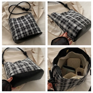 Detail of plaid bucket bag with bow embroidery and premium leather bottom stitching