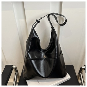 Detailed view of large black leather hobo bag with adjustable strap and silver metal buckle