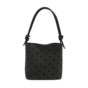 Minimalist dark grey canvas bucket bag with black polka dots and knot strap detail