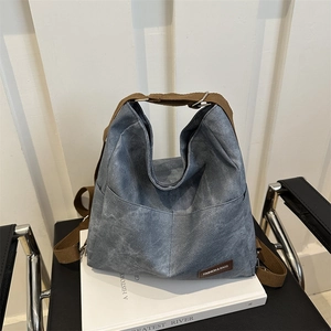 Blue denim hobo tote bag with brown adjustable strap for casual daily commuting