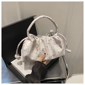 Close-up of white cloud bag featuring pink butterfly print and drawstring details