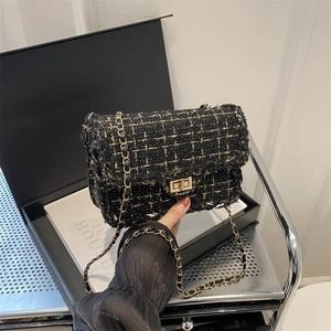 Elegant black tweed shoulder bag with gold chain strap and vintage metal turn-lock