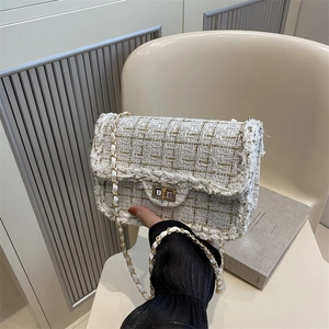 Elegant white tweed chain crossbody bag with gold metallic weaving and turn-lock closure