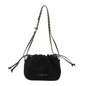 Chic black velvet drawstring bucket bag with gold chain strap and metal ball detail