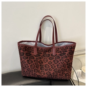 Detail of red-brown leopard print tote bag with durable PU leather handles and gray lining