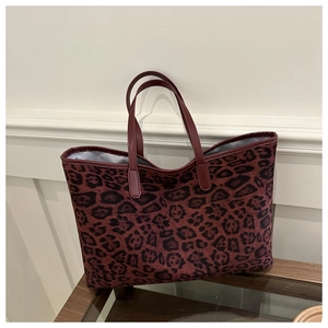 Detail of spacious leopard print tote bag interior with soft lining and suede texture