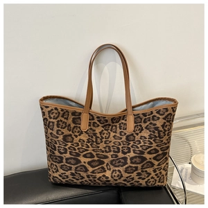 Close-up of leopard print tote bag with camel leather trim and soft light blue lining