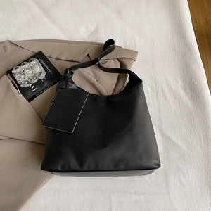 Detailed top view of a black large tote bag with a matching small coin purse