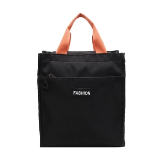 Minimalist black canvas tote bag with vibrant orange handles and fashion label detail