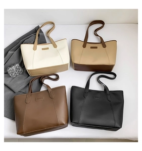 Detailed top view of large minimalist tote bags in cream, khaki, brown, and black colors