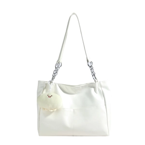 Minimalist white faux leather tote bag with silver chain details and plush smiley charm