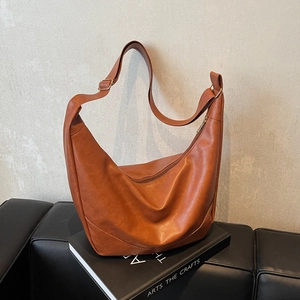 Brown faux leather crescent shoulder bag with adjustable strap and large capacity