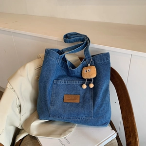 Blue denim canvas tote bag with brown leather label and cute plush toast keychain accessory