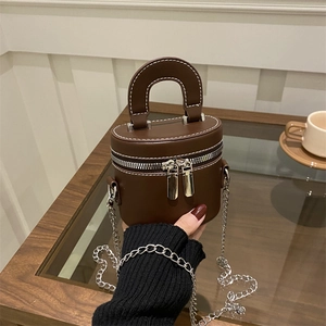 Brown leather vanity bag with white stitching and silver chain strap for women