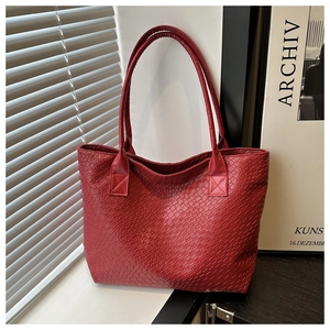 Detailed view of dark red woven texture tote bag with reinforced handles and large capacity