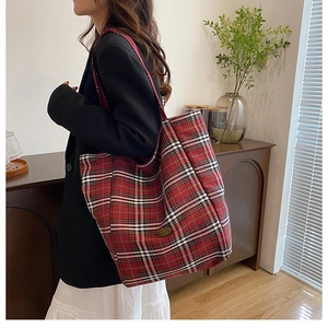 Detail view of the red and black plaid tote bag showing the high-quality cotton canvas texture