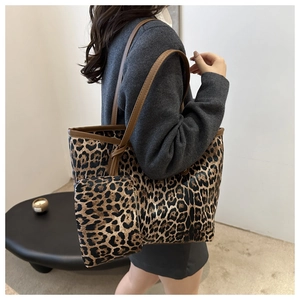 Detail view of large leopard print tote bag with matching pouch and brown straps