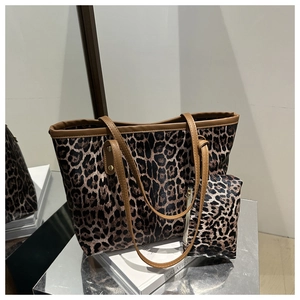 Detailed view of leopard print tote bag set with matching pouch on silver display