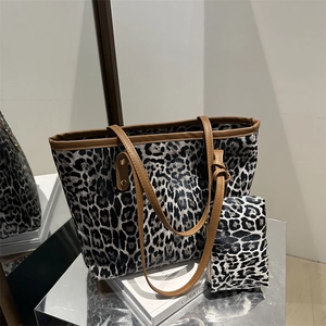 Fashionable leopard print tote bag set with brown leather handles and matching small pouch