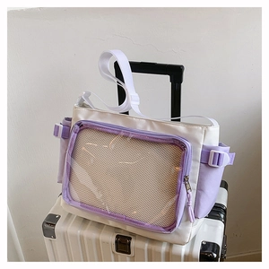 Detail of white and purple Ita bag showing the transparent PVC pocket on a suitcase