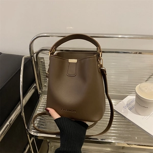 Deep brown matte PU leather bucket bag with top handle and adjustable shoulder strap