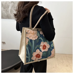 Detail of artistic floral canvas tote bag with thick rope handles and oil painting print