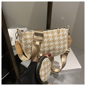 Detail of houndstooth crossbody bag with champagne gold strap and mini round coin purse