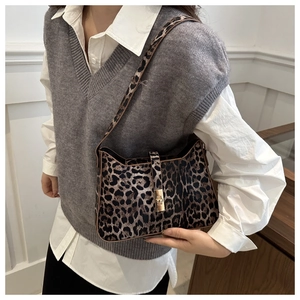 Detail of leopard print shoulder bag featuring gold twist lock and fine faux leather texture