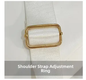 Close-up of golden metal adjustment ring on a white woven leopard backpack strap
