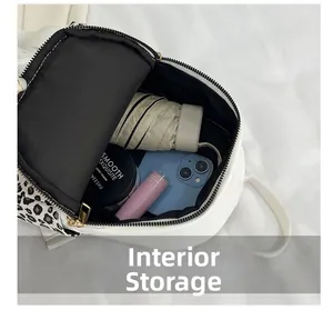 Internal storage view of leopard print backpack with umbrella and phone inside
