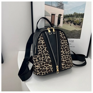 Detail of leopard print mini backpack with dual gold zippers and fabric shoulder strap