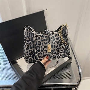 Handheld leopard print underarm bag with gold metal lock in a black gift box
