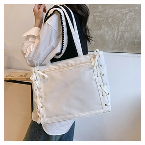 Dettaglio borsa ita in tela bianca con finestra in PVC e decorazione di nastri