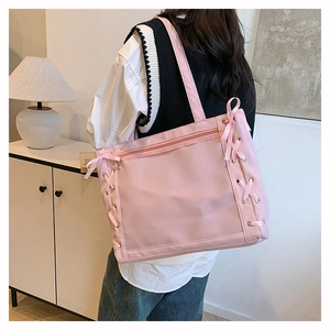 Detail of pink ita bag with transparent window and decorative ribbon cross-stitching