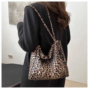Fashionable leopard print tote bag with magnetic closure shown on a model's shoulder
